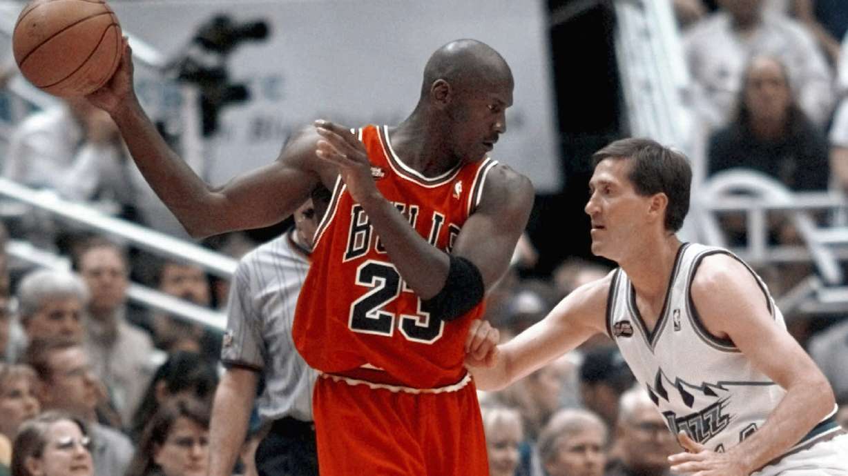 Chicago Bulls' Michael Jordan pulls the ball out of reach of Utah Jazz guard Jeff Hornacek during Game 2 of the NBA Finals in Salt Lake City, June 5, 1998.
