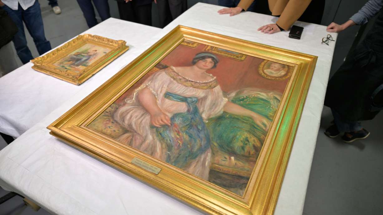 Recovered paintings "Portrait of Madame Colonna Romano", right, and "Young Woman at the Well," stolen from the Renoir Museum in Cagnes-sur-Mer are on display at the Interdisciplinary Centre for the Conservation and Restoration of Heritage in Marseille, France, Monday.
