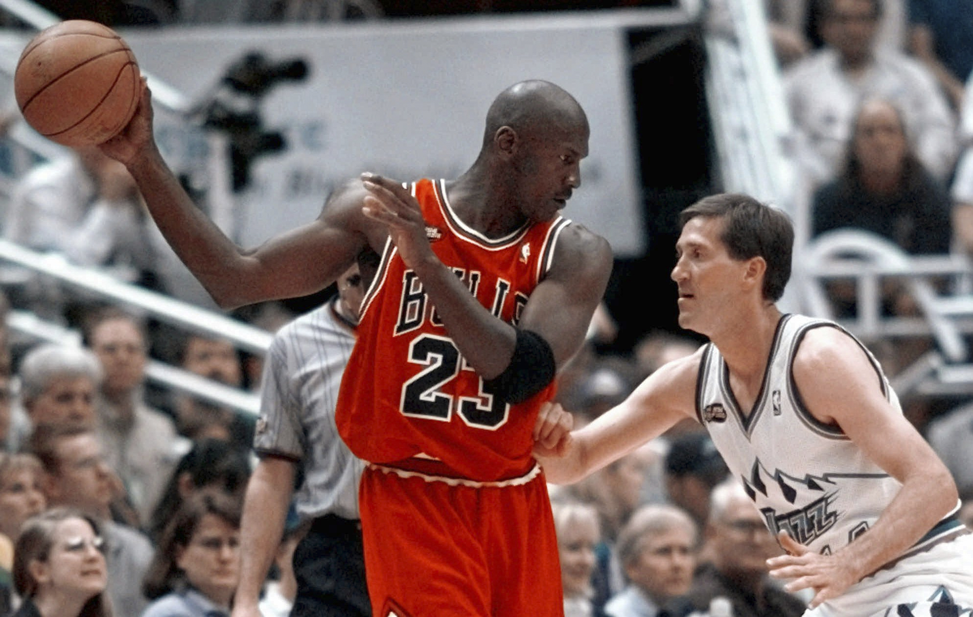 FILE - Chicago Bulls' Michael Jordan pulls the ball out of reach of Utah Jazz guard Jeff Hornacek during third quarter action in Game 2 of the NBA Finals in Salt Lake City, June 5, 1998. 