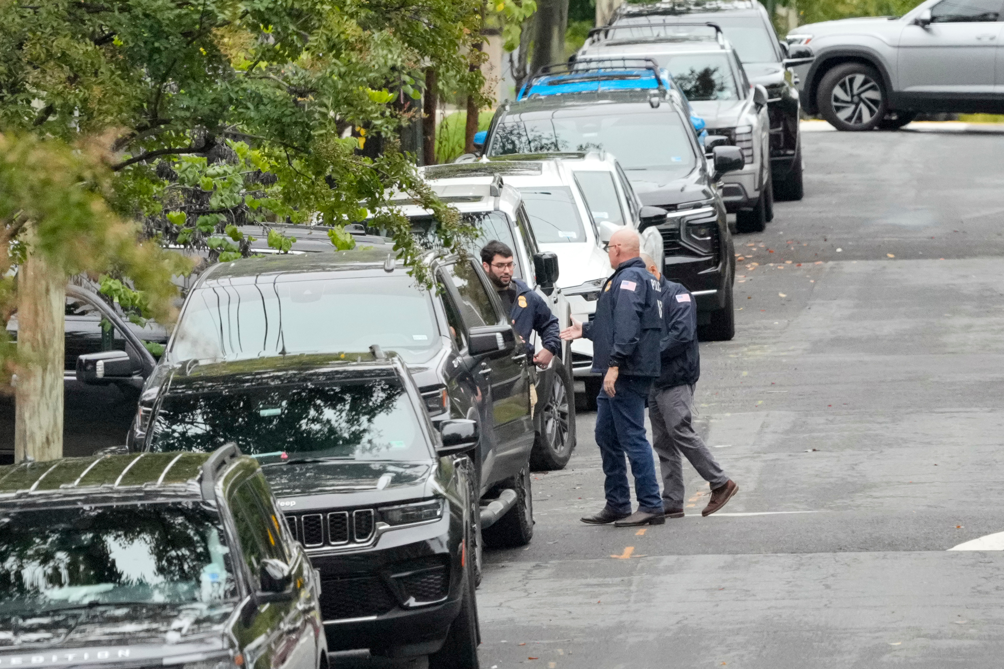 Homeland Security officers stand on 26th Street NE in Washington, early Monday, during an investigation at the residence of Rep. Ilhan Omar, D-Minn.