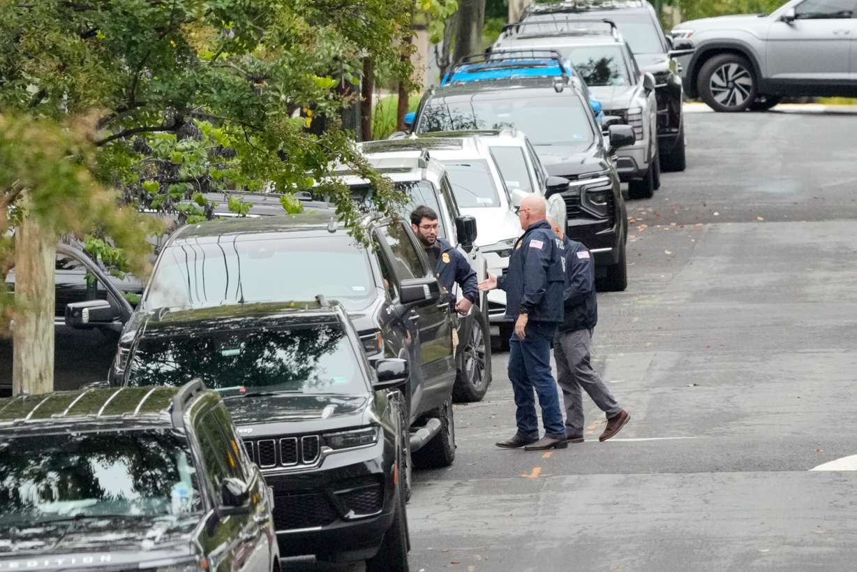 Homeland Security officers stand on 26th Street NE in Washington, early Monday, during an investigation at the residence of Rep. Ilhan Omar, D-Minn.