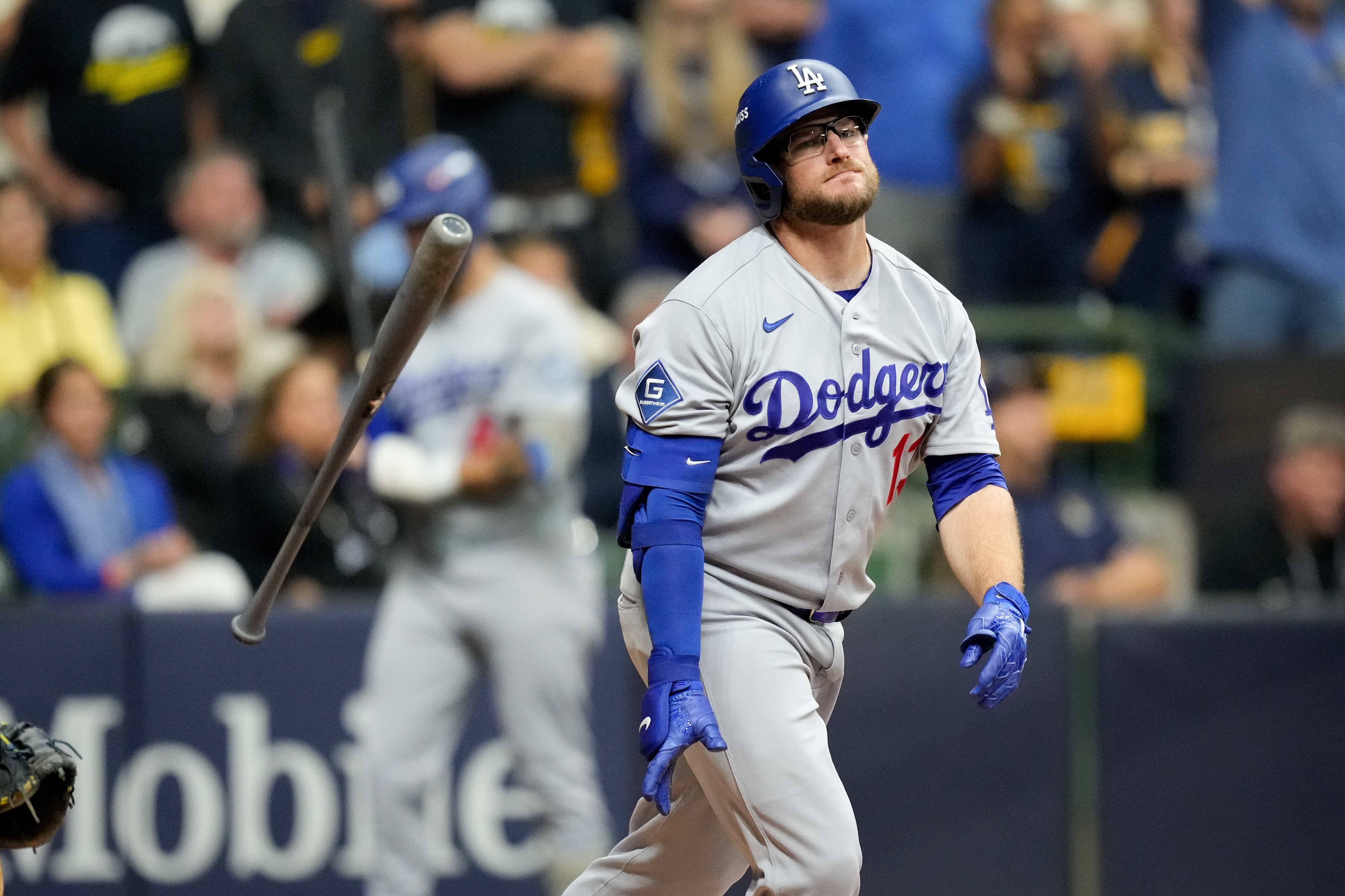 Los Angeles Dodgers third baseman Max Muncy flips his bat after popping out during the ninth inning of Game 1 of baseball's National League Championship Series between the Milwaukee Brewers and the Los Angeles Dodgers, Sunday, Oct. 11, 2026, in Milwaukee. 