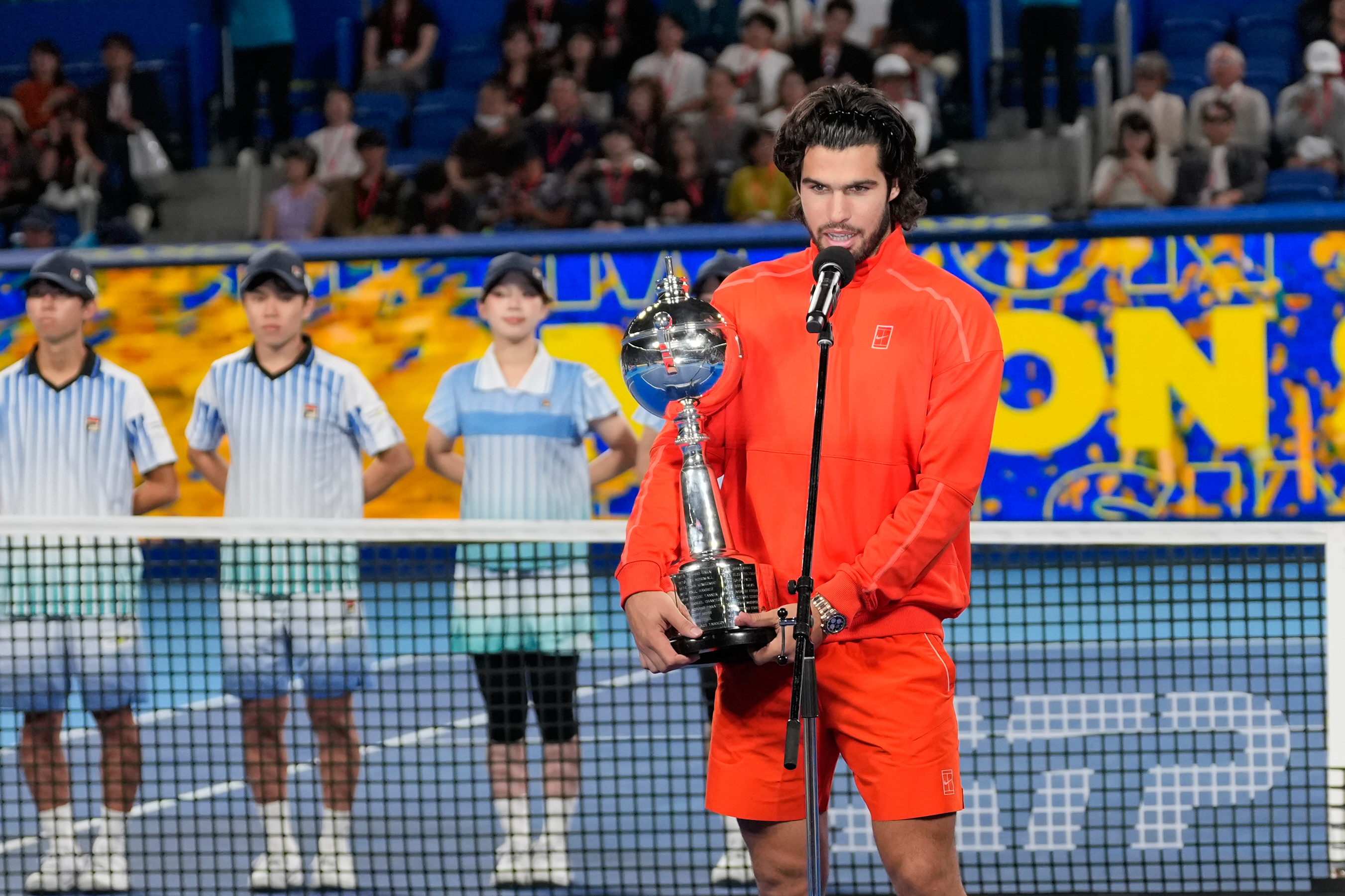 Spain's Carlos Alcaraz speaks holding the trophy after winning the men's singles final against Czechia's Jiri Lehecka at the Japan Open tennis tournament in Tokyo, Tuesday, Oct. 6, 2026. 