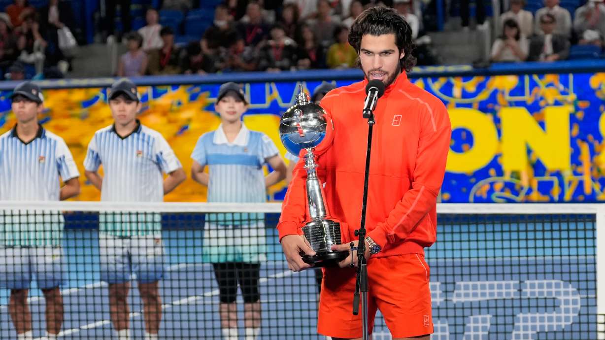 Spain's Carlos Alcaraz speaks holding the trophy after winning the men's singles final against Czechia's Jiri Lehecka at the Japan Open tennis tournament in Tokyo, Tuesday, Oct. 6, 2026.