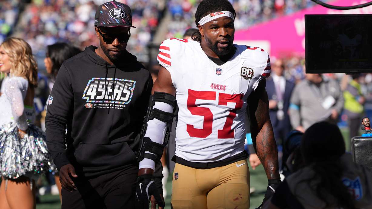 San Francisco 49ers linebacker Dre Greenlaw (57) leaves the field after being ejected during the first half of an NFL football game against the Seattle Seahawks, Sunday, Oct. 11, 2026, in Seattle.