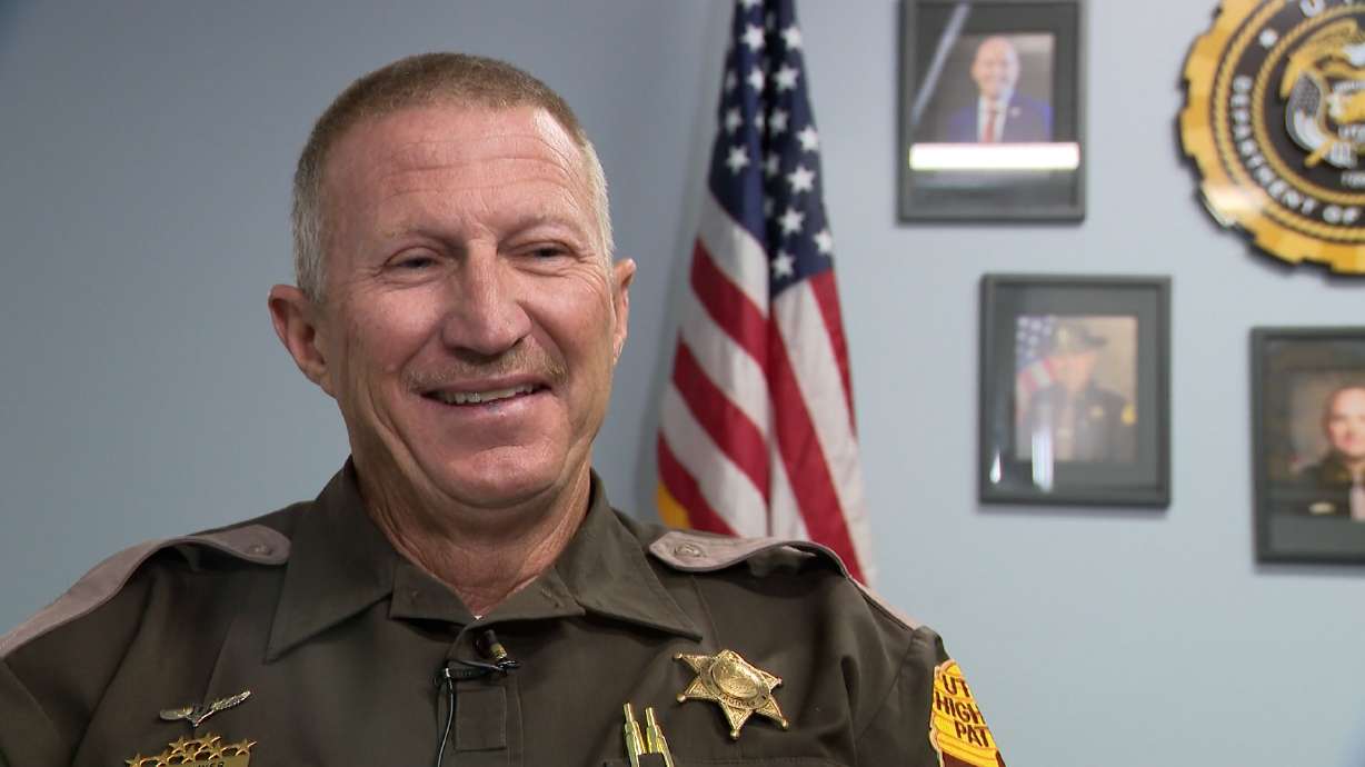 Steve "Odie" Myer is pictured while being interviewed by KSL's Alex Cabrero. After nearly dying in a fall from an overpass, he has returned to patrol.