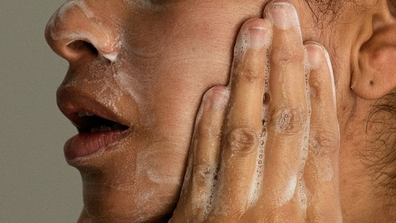 A woman washes her face as she prepares for work in Chicago, Feb. 10, 2023. 