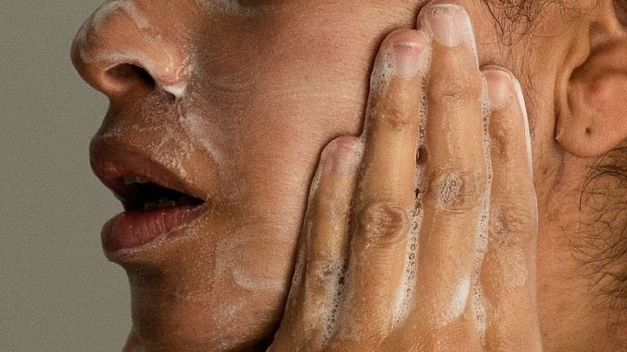 A woman washes her face as she prepares for work in Chicago, Feb. 10, 2023.