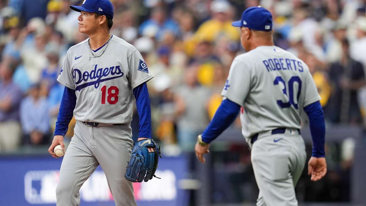 Los Angeles Dodgers manager Dave Roberts (30) pulls Los Angeles Dodgers pitcher Yoshinobu Yamamoto (18) from the game during the third inning of Game 2 of baseball's National League Championship Series between the Milwaukee Brewers and the Los Angeles Dodgers, Monday, Oct. 12, 2026, in Milwaukee.