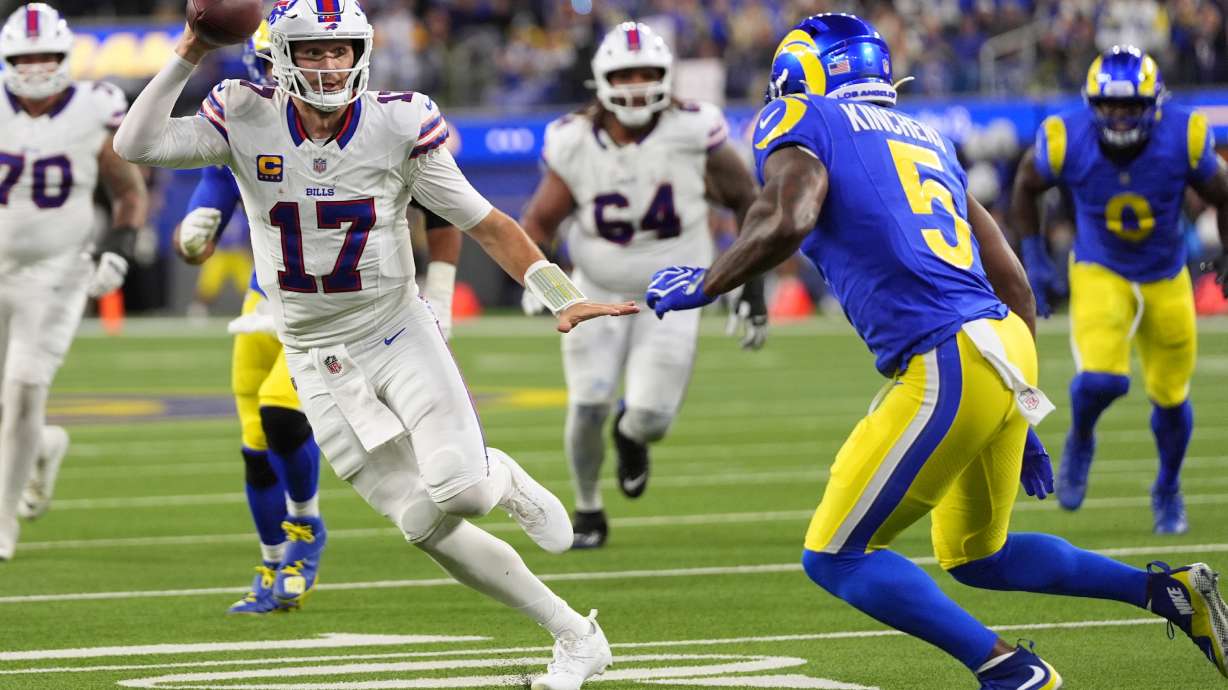 Buffalo Bills quarterback Josh Allen, left, runs the ball as Los Angeles Rams safety Kamren Kinchens defends during the second half of an NFL football game, Monday, Oct. 12, 2026, in Inglewood, Calif.
