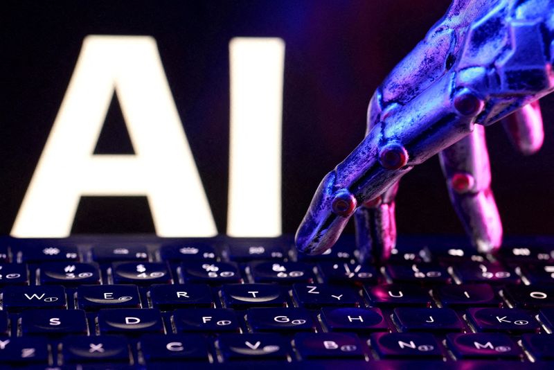 FILE PHOTO: Letters spelling "AI," a keyboard and a robotic hand in this illustration created on September 23, 2026.