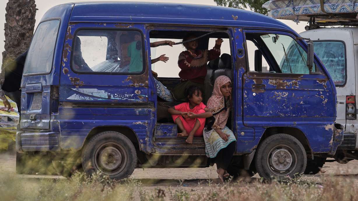 Displaced Yemeni children sit in a vehicle as families gather to receive aid at the Al-Fallahine displacement camp in Dar Saad district, Aden, Yemen, Monday. A Saudi-led coalition called for Sanaa's evacuation ahead of "operations" at an oil site.