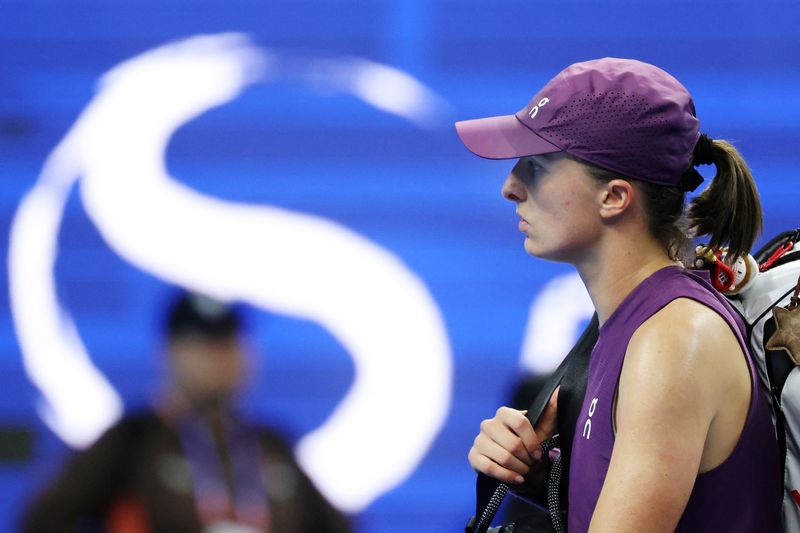 Tennis - China Open - National Tennis Center, Beijing, China - October 9, 2026 Poland's Iga Swiatek looks dejected after losing her quarter final match against Belgium's Elise Mertens