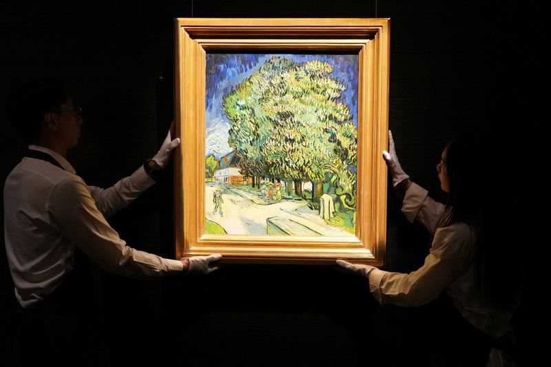 Staff members pose with Vincent van Gogh's "Chataigniers en fleurs" (Chestnut Trees in Blossom) at a media preview ahead of its auction in New York, at Sotheby's in Hong Kong, China, October 13, 2026.