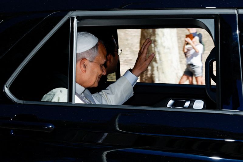 Pope Leo XIV waves from a car window as he leaves the Vatican, ahead of his hospitalization for surgery to remove a lung nodule, in Rome, Italy, Tuesday.