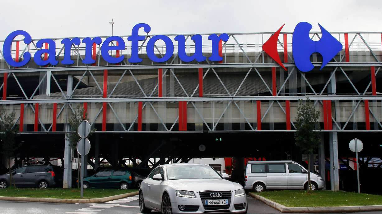 A car leaves a Carrefour supermarket in Anglet, southwestern France, on Jan. 23, 2018. The French chain was one of several European supermarket chains to be hit by cyberattacks affecting refrigeration systems on Tuesday.