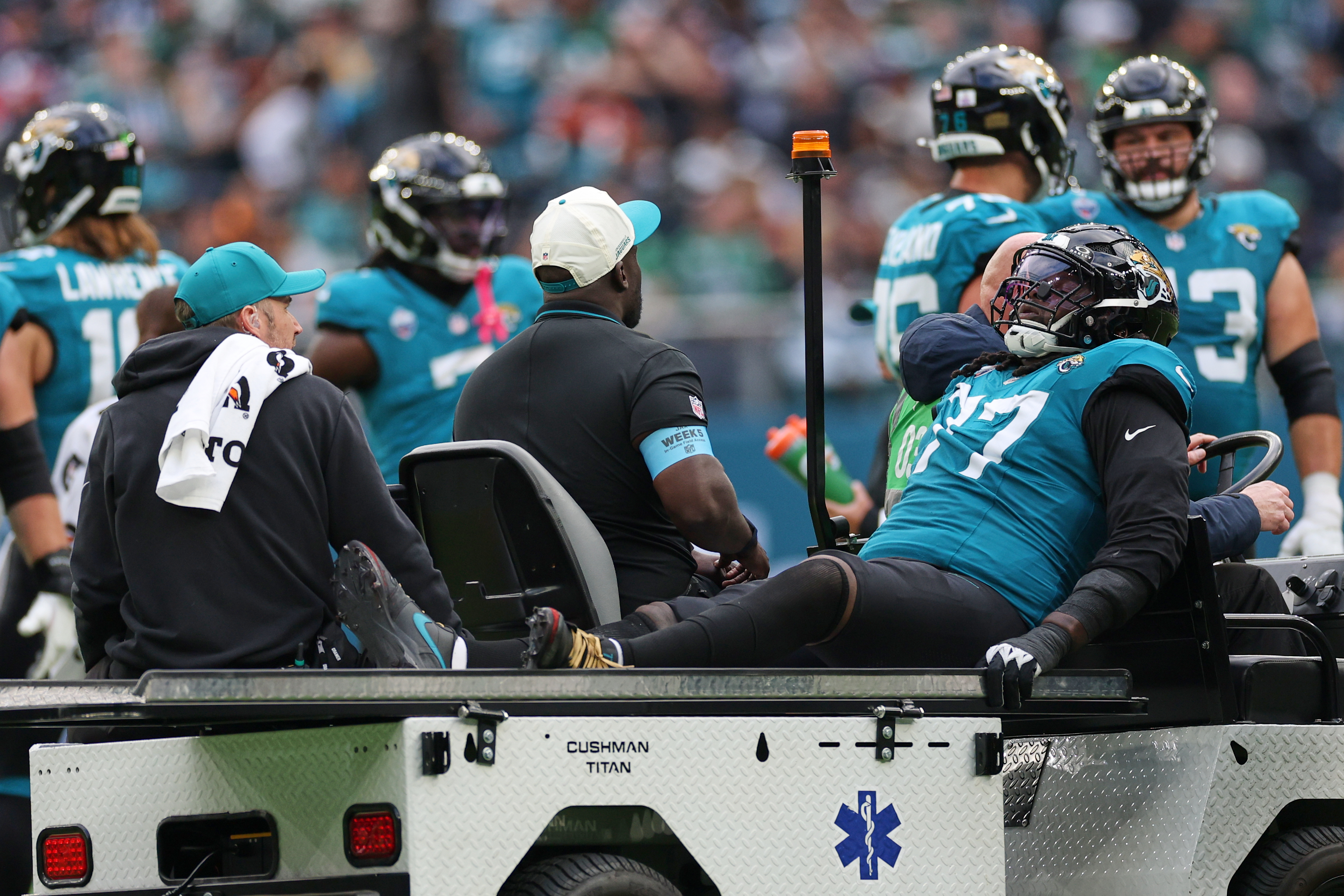 Jacksonville Jaguars offensive tackle Anton Harrison (77) is driven from the field after an injury during an NFL football game against Philadelphia Eagles in London, Sunday, Oct. 11, 2026.