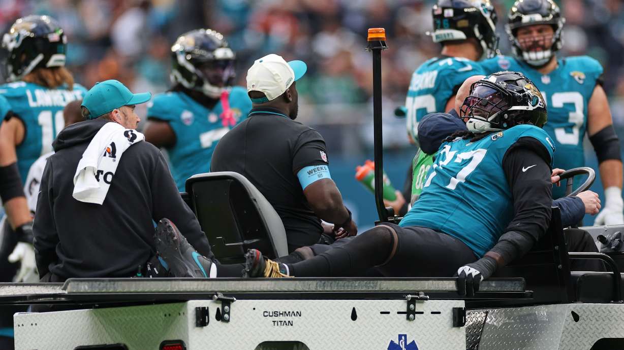 Jacksonville Jaguars offensive tackle Anton Harrison (77) is driven from the field after an injury during an NFL football game against Philadelphia Eagles in London, Sunday, Oct. 11, 2026.