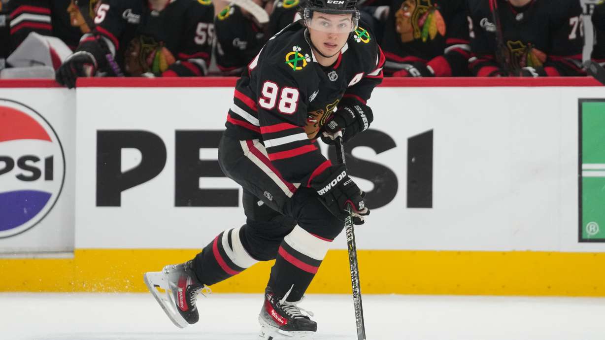 FILE - Chicago Blackhawks center Connor Bedard handles the puck during the second period of an NHL hockey game against the Colorado Avalanche, March 20, 2026, in Chicago.