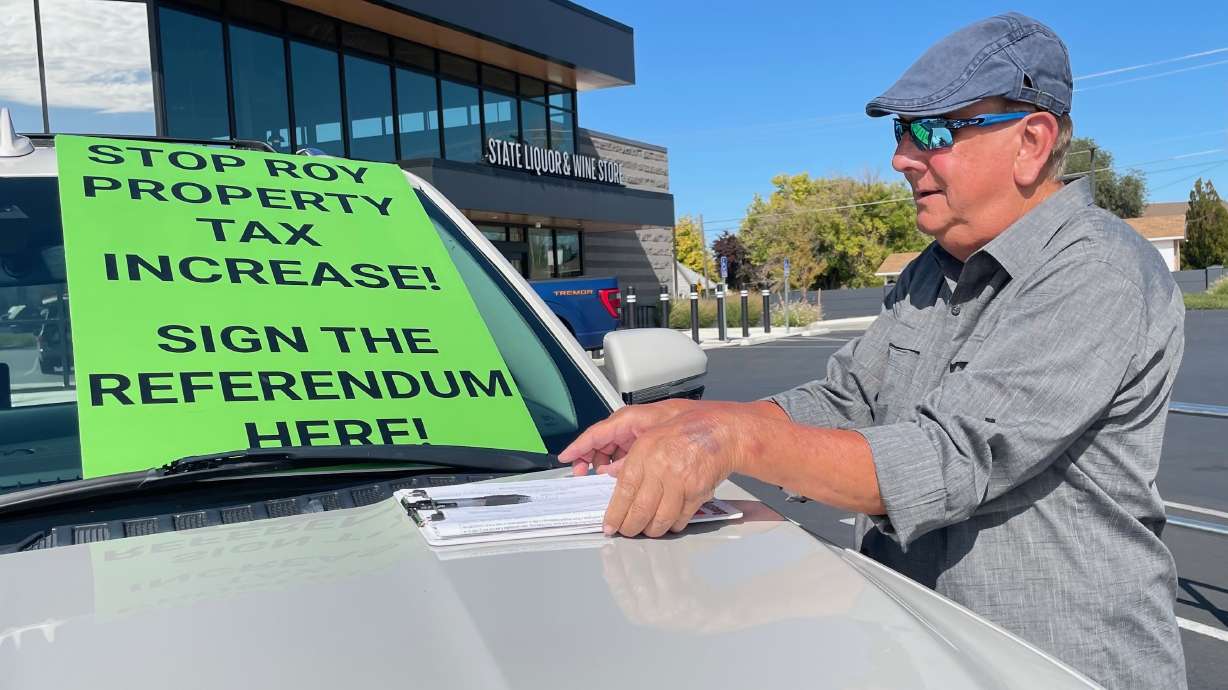 Roy petitioners upset over the 34.25% tax hike the City Council approved in August have gotten enough signatures to force a vote on the increase. Geoffrey Cox, one of the petitioners, is pictured Oct. 6 in Roy as he was gathering signatures.