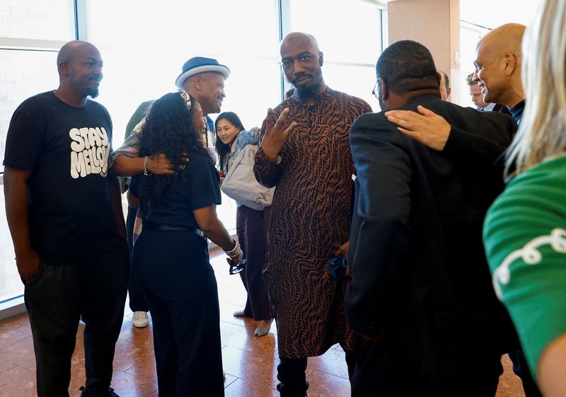Friends and family members of rapper Tupac Shakur, and Darryl Harper, who says he is Shakur's music producer, celebrate outside a courtroom after a jury found Duane Davis, guilty in the 1996 killing of Shakur, in Clark County District Court at the Regional Justice Center on Aug. 31 in Las Vegas. Davis was sentenced to 40 years to life in prison on Tuesday.