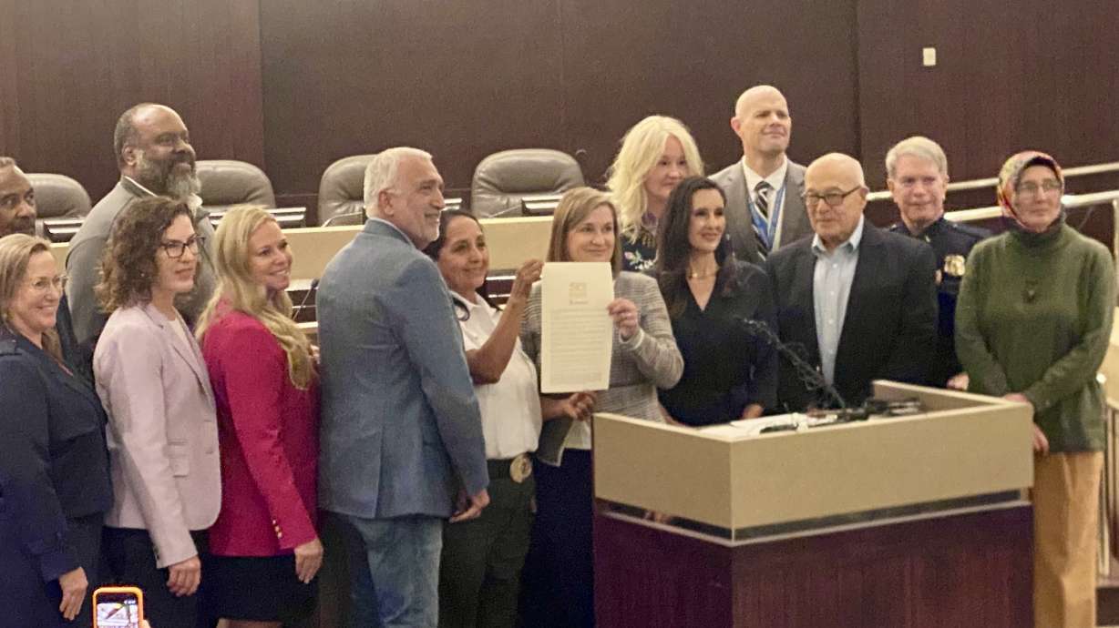 Salt Lake County District Attorney Sim Gill, Sheriff Rosie Rivera, Mayor Jenny Wilson, County Council member Dea Theodore and others hold a proclamation signed Tuesday pledging to take a stand against hate.