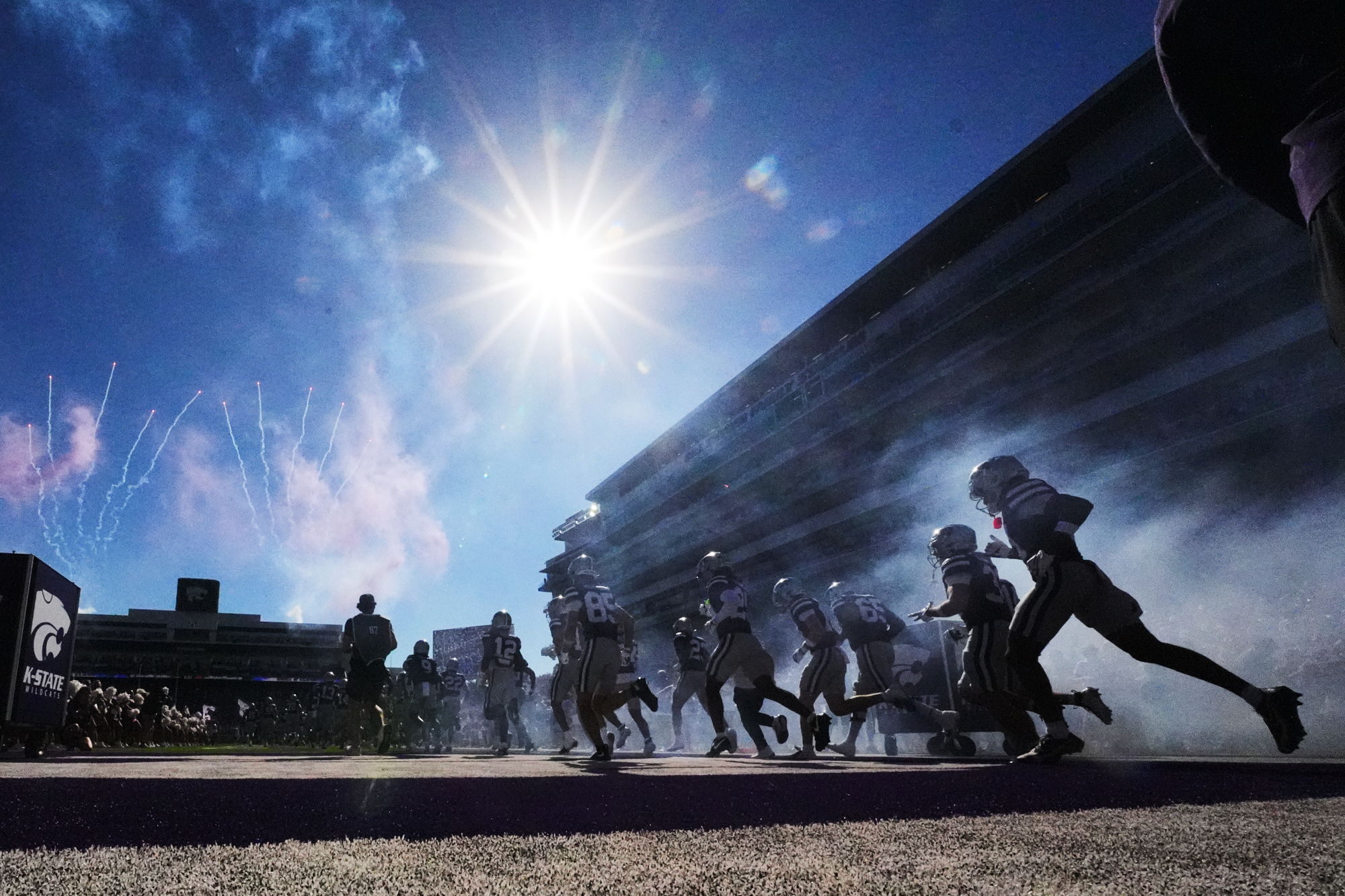 Kansas State players run onto the field before an NCAA college football game against Houston, Saturday, Oct. 10, 2026, in Manhattan, Kan. 