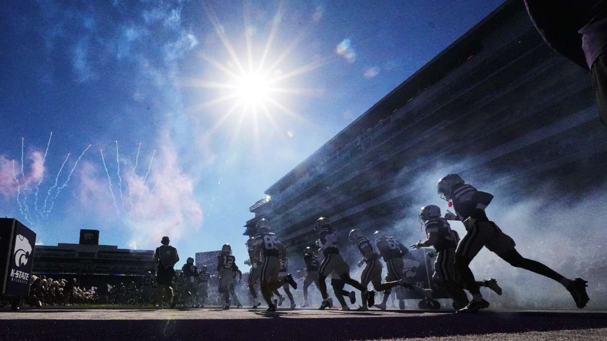 Kansas State players run onto the field before an NCAA college football game against Houston, Saturday, Oct. 10, 2026, in Manhattan, Kan.