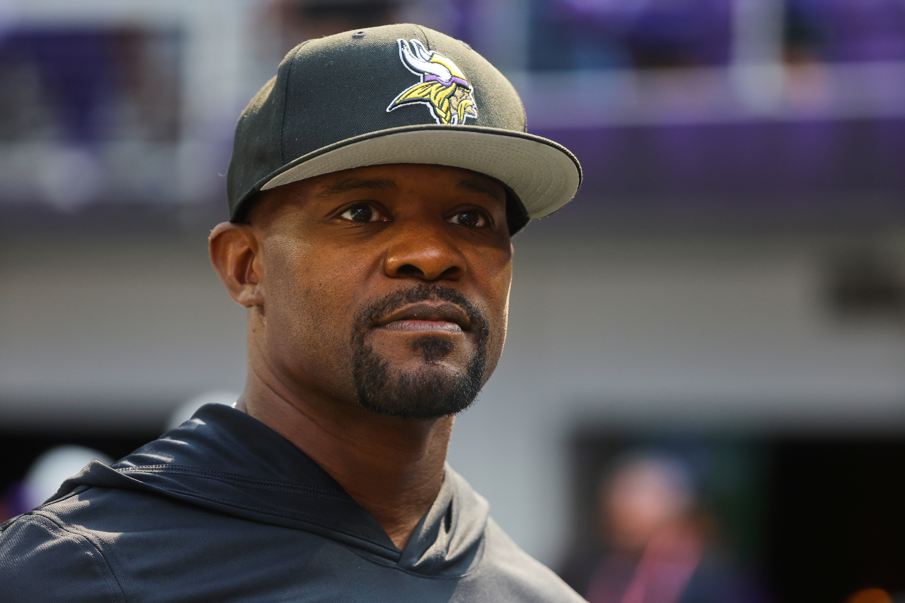 FILE - Minnesota Vikings defensive coordinator Brian Flores watches during warm ups before an NFL preseason football game against the Baltimore Ravens, Aug. 22, 2026, in Minneapolis. 