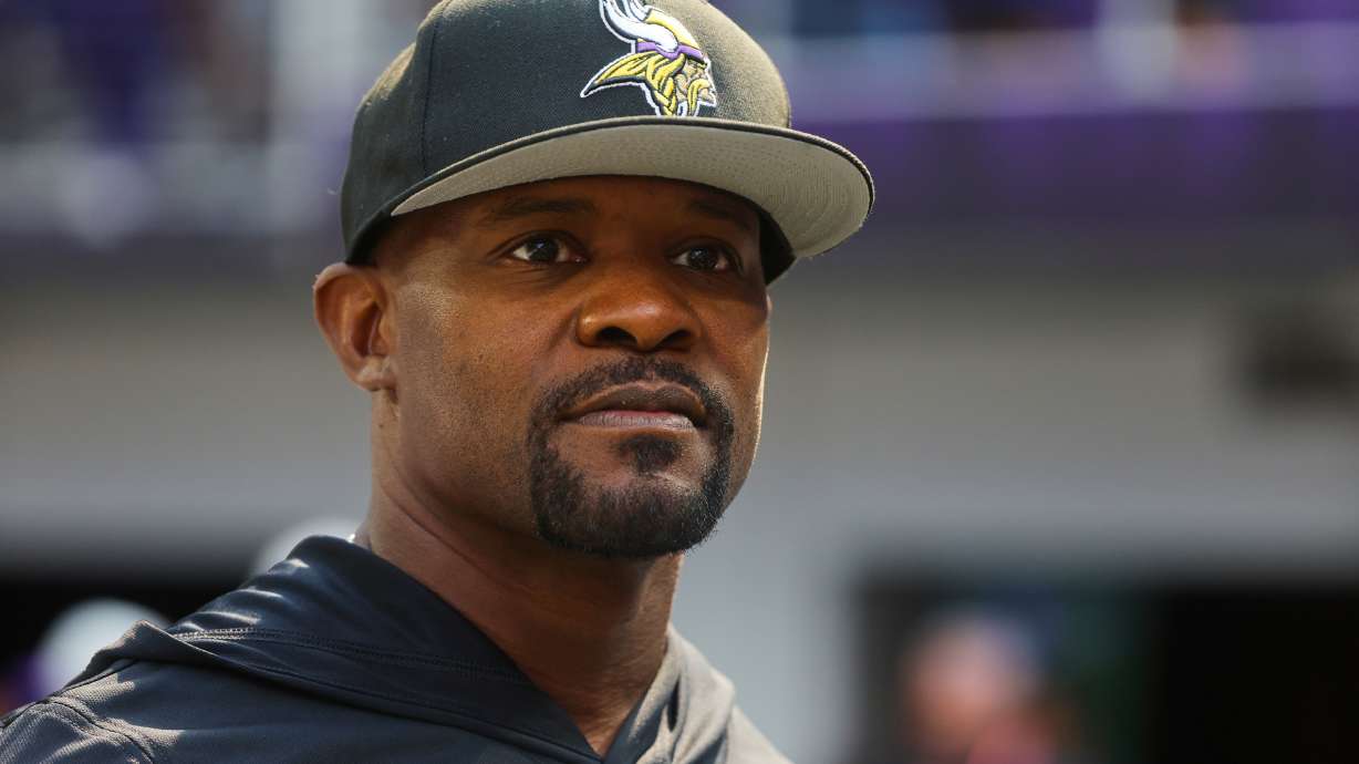 FILE - Minnesota Vikings defensive coordinator Brian Flores watches during warm ups before an NFL preseason football game against the Baltimore Ravens, Aug. 22, 2026, in Minneapolis.