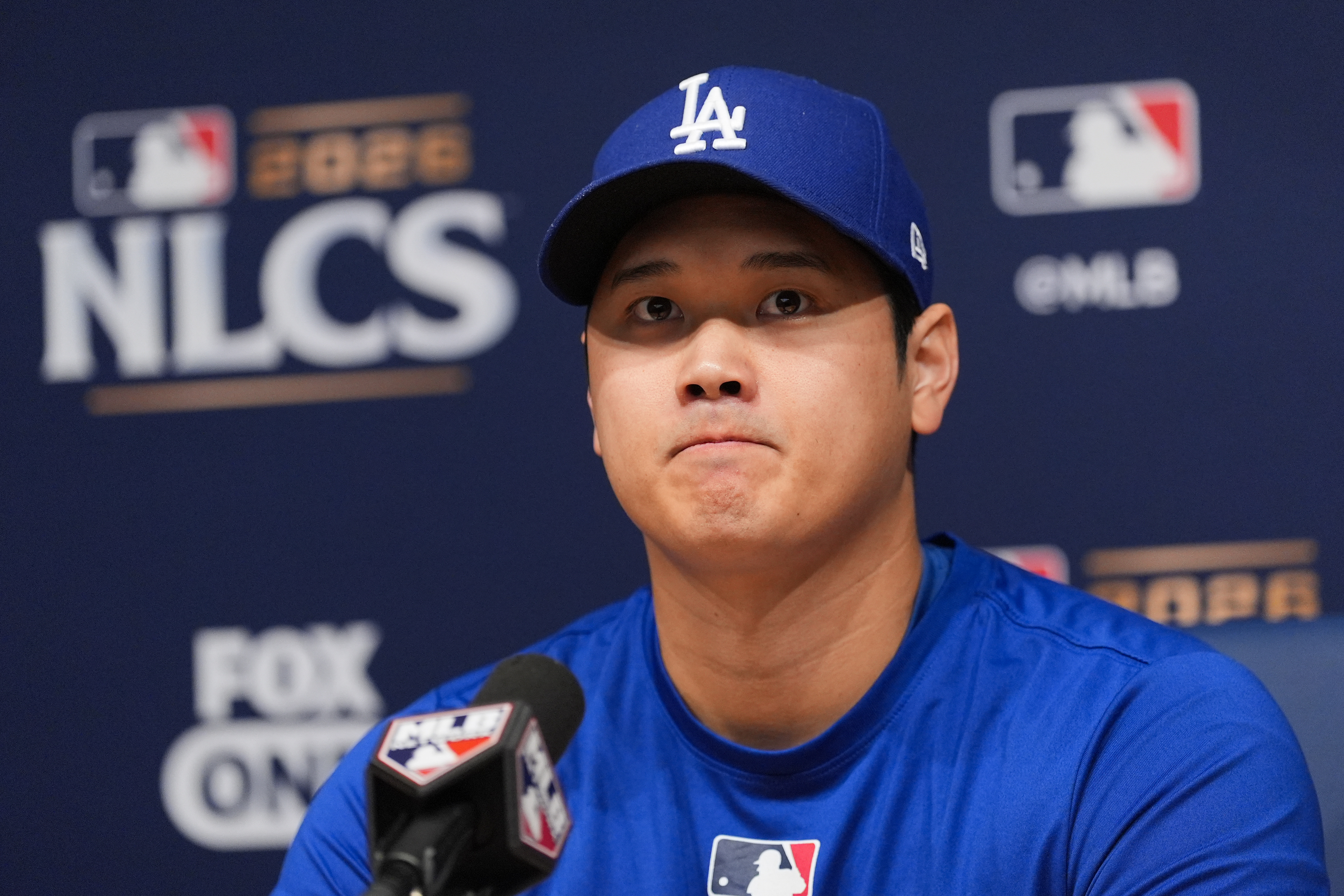 Los Angeles Dodgers' Shohei Ohtani listens to questions from the media during a news conference ahead of Game 3 of baseball's National League Championship Series against the Milwaukee Brewers, Tuesday, Oct. 13, 2026, in Los Angeles. 