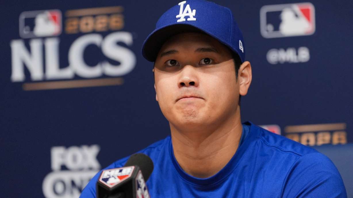 Los Angeles Dodgers' Shohei Ohtani listens to questions from the media during a news conference ahead of Game 3 of baseball's National League Championship Series against the Milwaukee Brewers, Tuesday, Oct. 13, 2026, in Los Angeles.