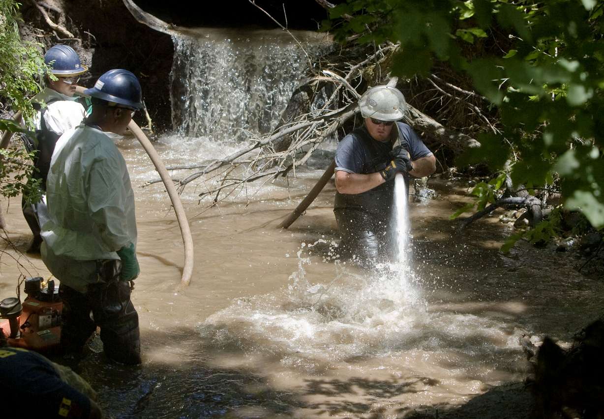 Members of the Red Butte Canyon Spill Unified Command Cleanup Operation crew uses a fire float to wash the bank of the Red Butte Creek behind the VA Hospital in Salt Lake City, Utah June 28, 2010. This group is made up of Chevron, The United States Environmental Protection Agency, the Utah Department of Environmental Quality, Salt Lake County and Salt Lake Valley Health Department after an oil spill in the creek.