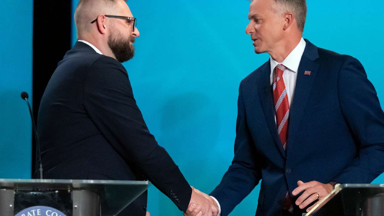 Candidates for Utah’s 2nd Congressional District, Democrat Peter Crosby, left, and Rep. Blake Moore, R-Utah, shake hands following a debate at Utah State University, Tuesday in Logan.
