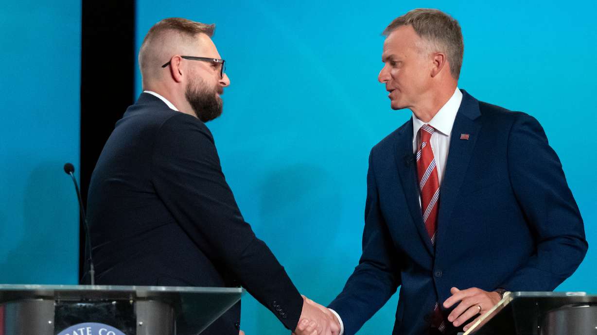 Candidates for Utah’s 2nd Congressional District, Democrat Peter Crosby, left, and Rep. Blake Moore, R-Utah, shake hands following a debate at Utah State University, Tuesday in Logan.