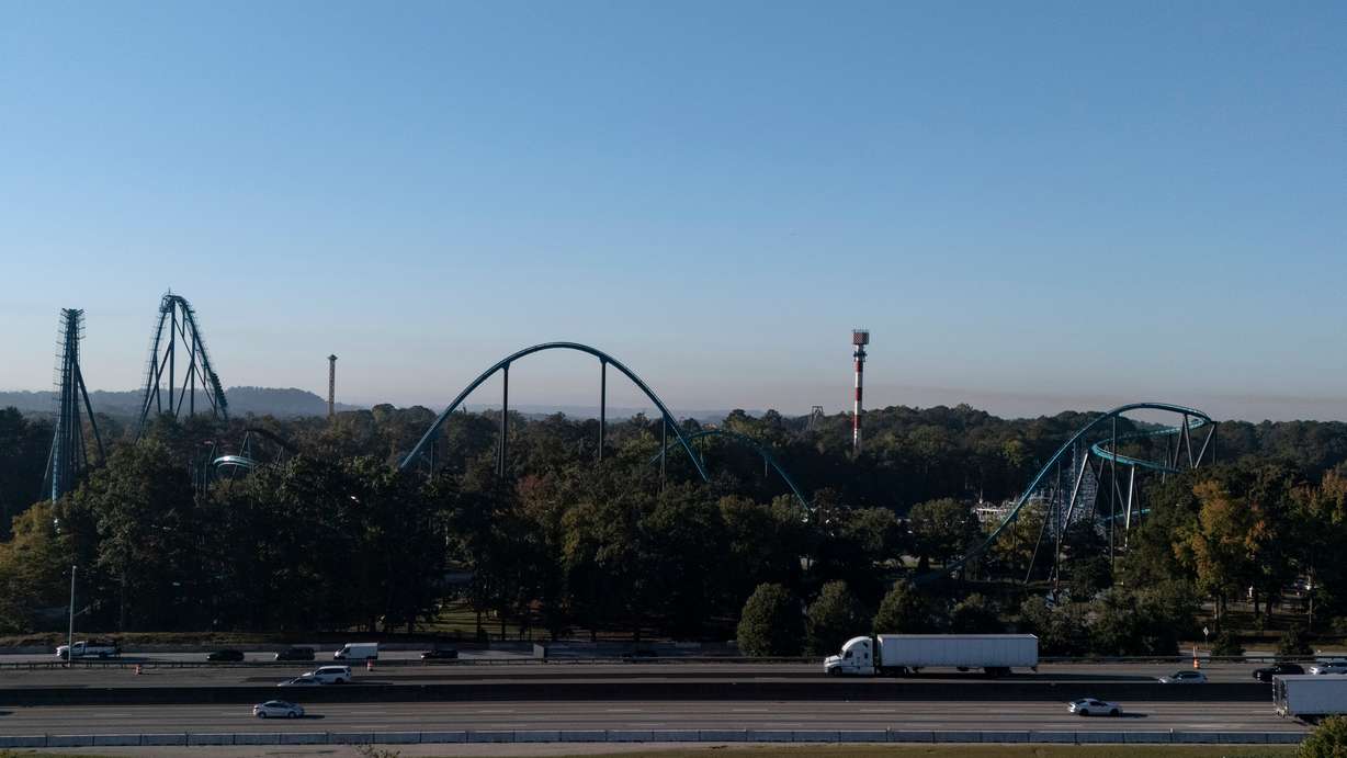 Attractions are seen near Interstate 20 at Six Flags Over Georgia, about 15 miles northwest of Atlanta, Tuesday. An incident that killed a man on a roller coaster at the park has raised new questions about safety.