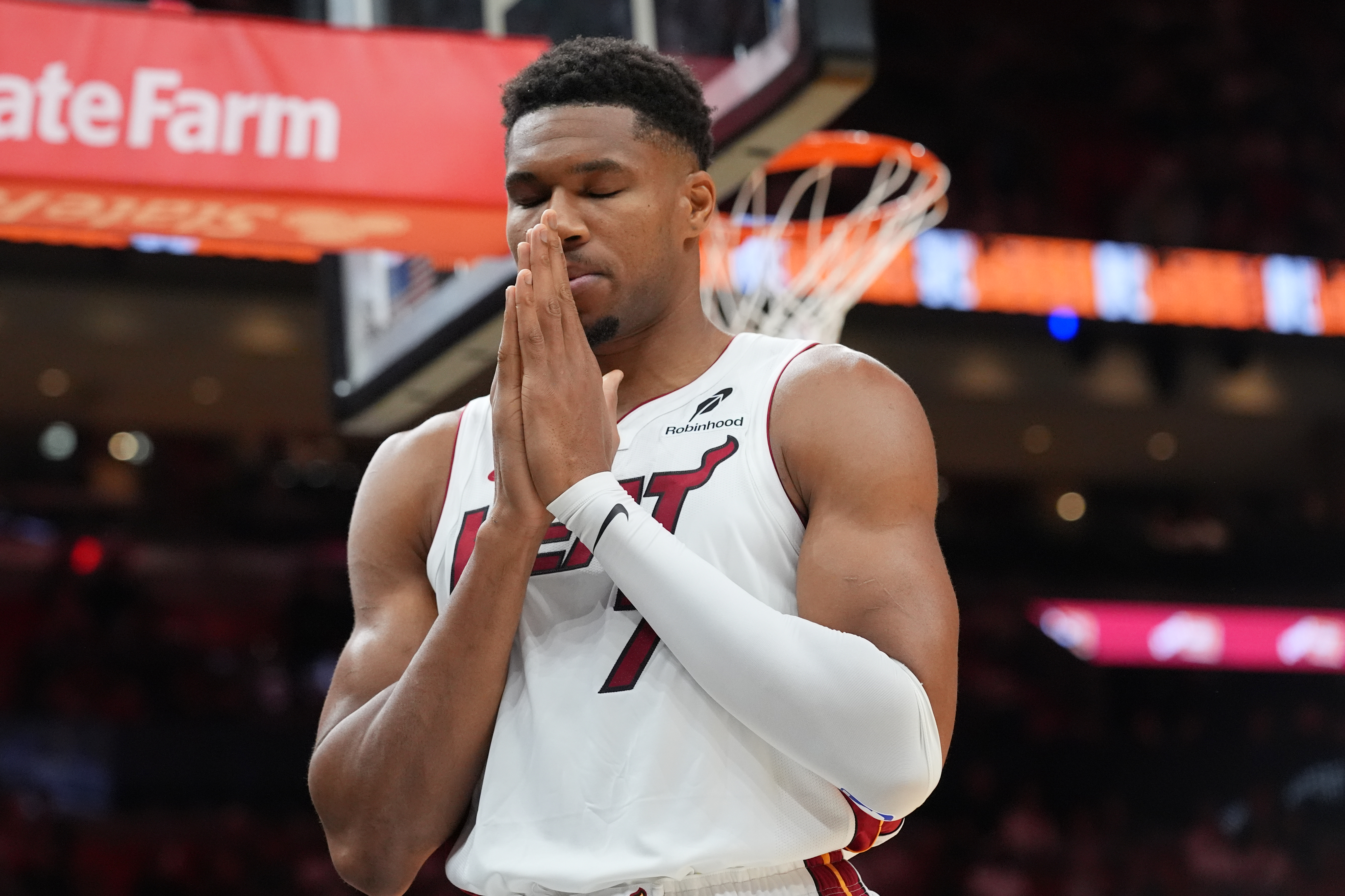 Miami Heat forward Giannis Antetokounmpo (7) has a moment of silence before the first half of an NBA preseason basketball game against the New Orleans PelicansThursday, Oct. 8, 2026, in Miami. 
