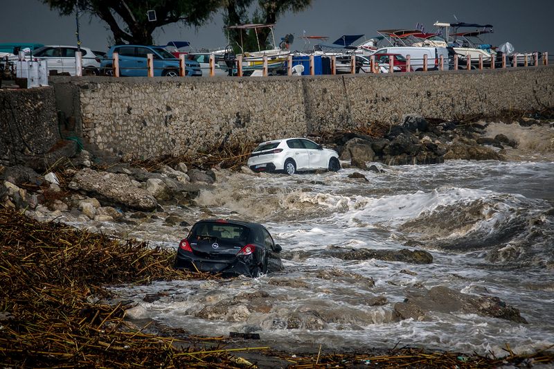 Cars are swept into the sea, following a heavy rainstorm on the Greek island of Rhodes, which left one person dead, authorities said, and flooded streets and caused rivers to overflow, at Stegna, Rhodes island, October 14, 2026. Argyris Mantikos/Eurokinissi via REUTERS
