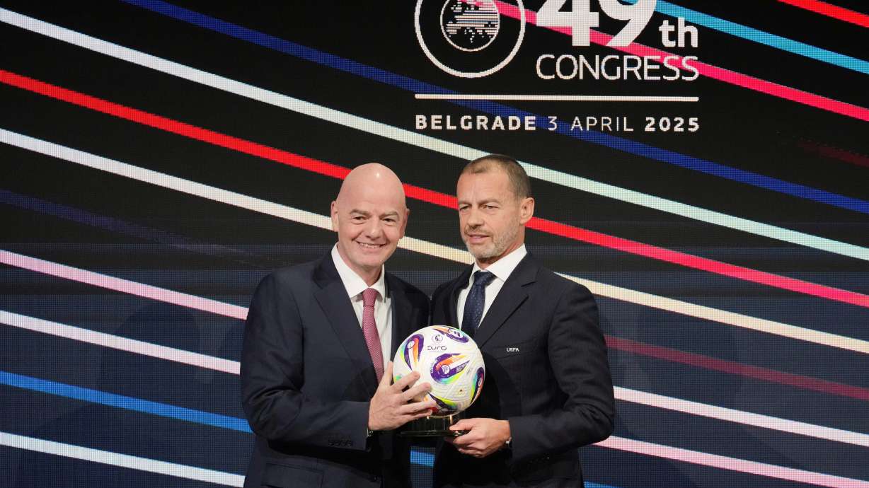 FILE - UEFA President Aleksander Ceferin, right, and FIFA president Gianni Infantino, left, holding a ball during the 49th UEFA congress in Belgrade, Serbia, April 3, 2025.