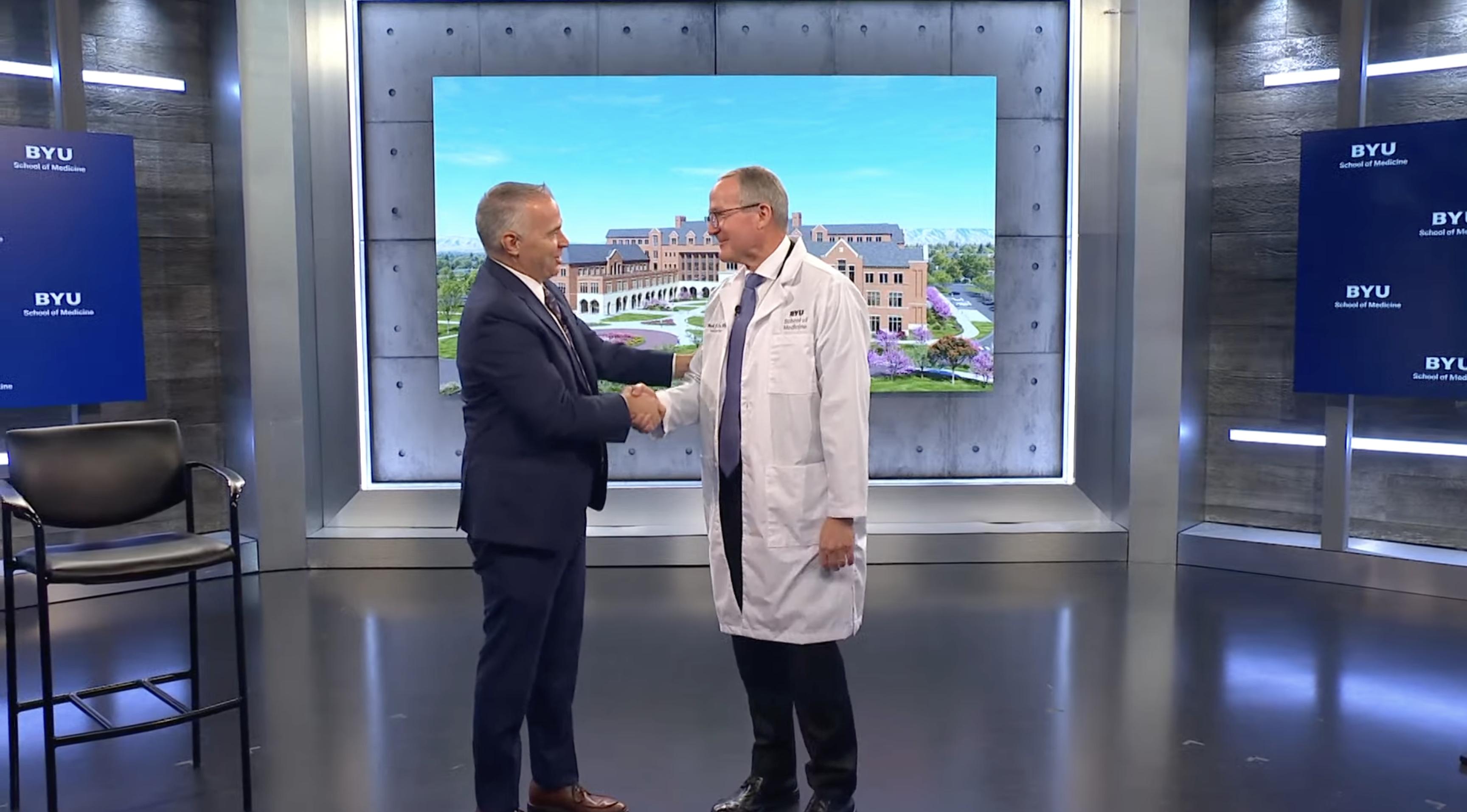 Brigham Young University President Shane Reese (left) shakes hands with Dr. Mark Ott, Dean of BYU's School of Medicine, after announcing the BYU's medical school received national accreditation.
