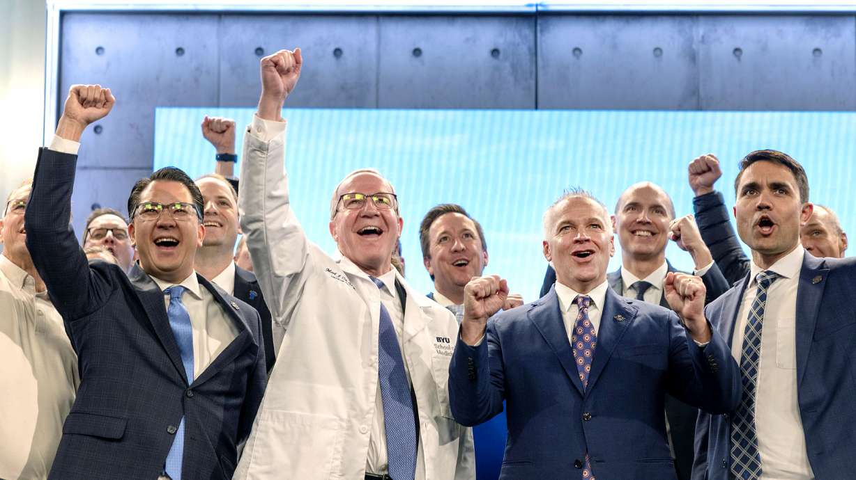Dr. Mark J. Ott, the inaugural dean of the Brigham Young University School of Medicine, President C. Shane Reese and others following an announcement that the school received preliminary accreditation, during a press conference on Wednesday in Provo.