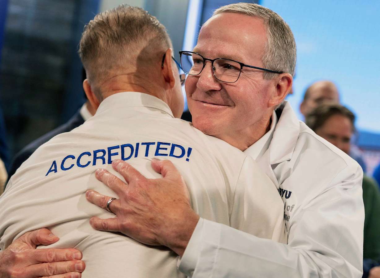 Dr. Mark J. Ott, the inaugural dean of the Brigham Young University School of Medicine, shares a hug with a colleague following an announcement that the School of Medicine has received preliminary accreditation, Wednesday in Provo.
