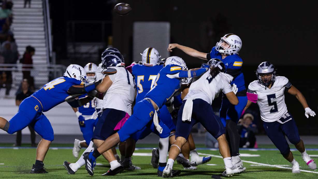 Cyprus’ Sidney McElreath (2) throws the ball under heavy pressure during a high school football game against Hunter at Cyprus High School in Magna on Friday, Oct. 9, 2026.