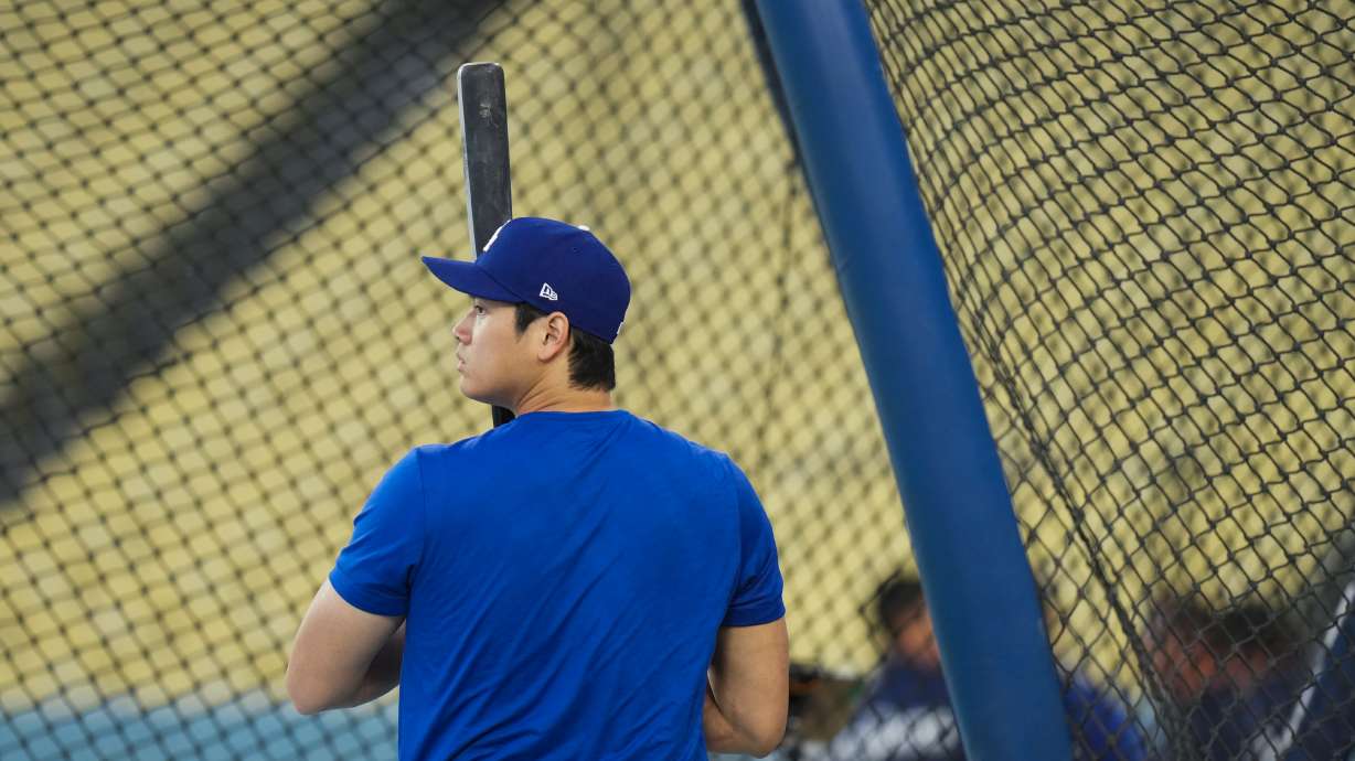 Los Angeles Dodgers' Shohei Ohtani enters the batting cage during a workout ahead of Game 3 of baseball's National League Championship Series against the Milwaukee Brewers, Tuesday, Oct. 13, 2026, in Los Angeles.