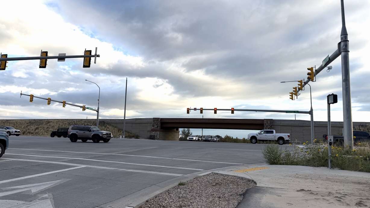 Cars drive along Timpanogos Highway in Lehi by the Center Street intersection on Wednesday. Lehi community members are urging UDOT to prioritize a pedestrian bridge for student safety.