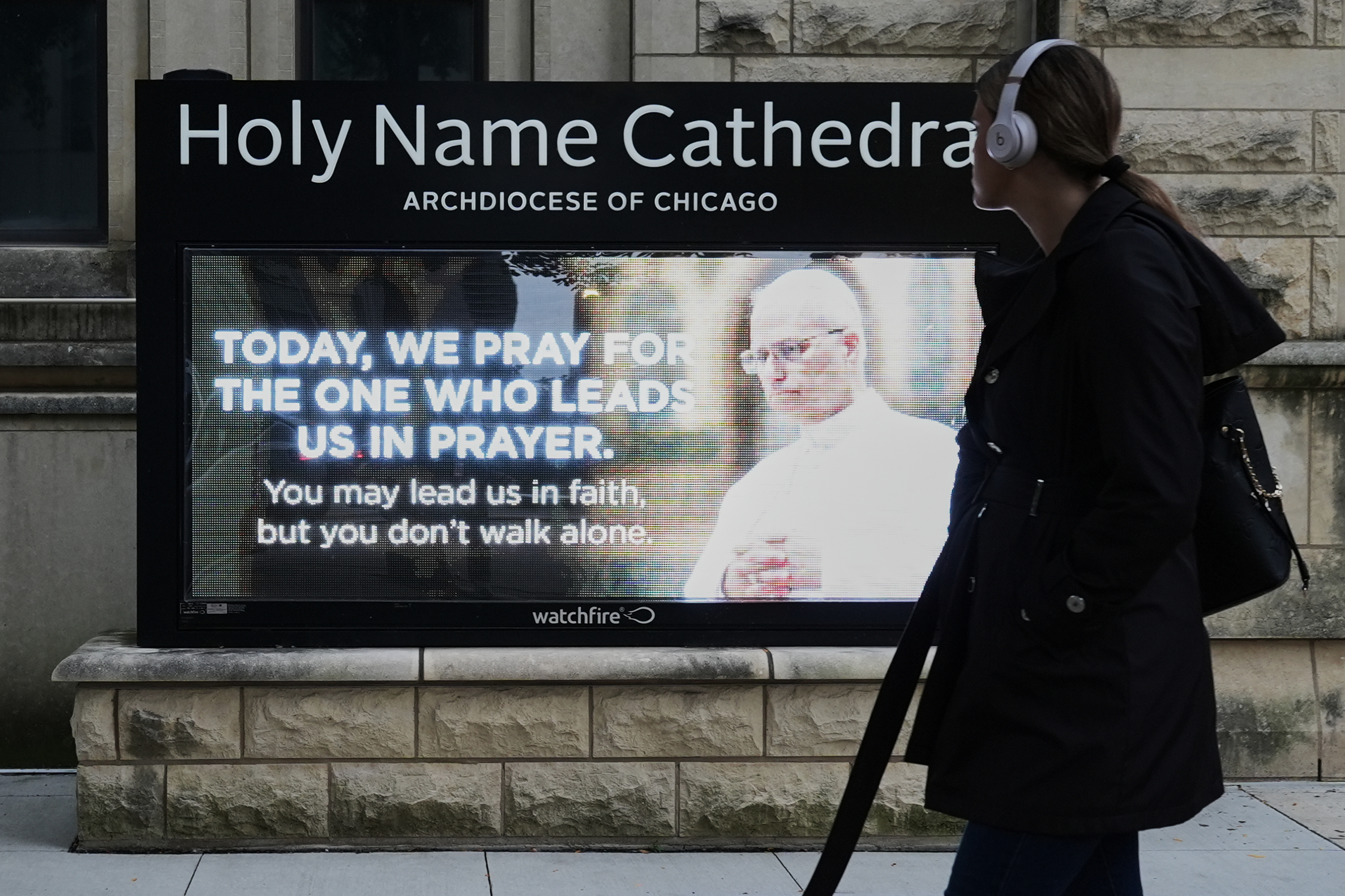 A pedestrian walks past Holy Name Cathedral in Chicago's calls for prayers, Wednesday, for Pope Leo XIV after his lung cancer diagnosis.
