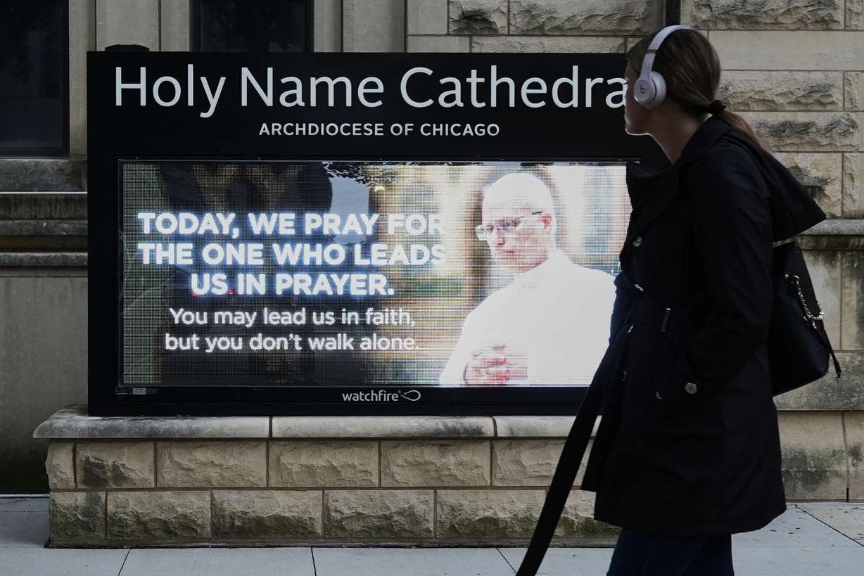 A pedestrian walks past Holy Name Cathedral in Chicago's calls for prayers, Wednesday, for Pope Leo XIV after his lung cancer diagnosis.