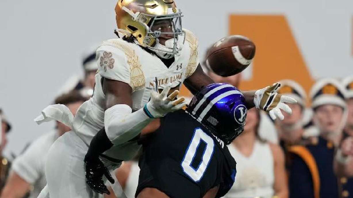 Notre Dame wide receiver Jayden Thomas (83) catches a pass over BYU defensive back Jakob Robinson (0) before running in for a touchdown during the first half of an NCAA college football game Oct. 8, 2022, in Las Vegas.
