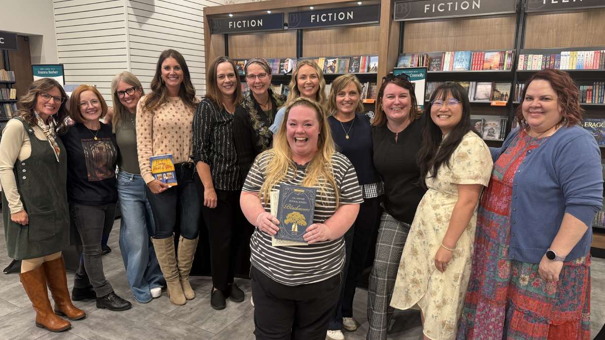 Local authors pose with a reader at a Deseret Book Author Showcase, featuring 10 female authors on Wednesday. Female authors are growing in number and popularity, in part due to off-page social events created by fans