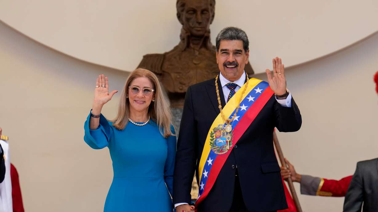 Then-Venezuelan President Nicolas Maduro and his wife Cilia Flores wave after his swearing-in ceremony for a third term at the National Assembly in Caracas, on Jan. 10, 2025. Maduro and Flores are due back in court on Thursday.